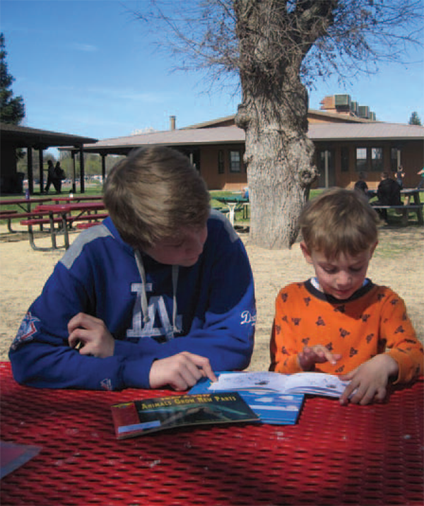 Travis helps his kindergarten buddy, Caden, work on his reading every week. (Photo courtesy the author.)