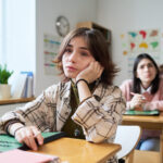 A bored student wants to ask their teacher for student involvement opportunities